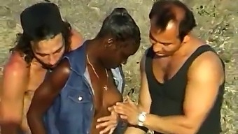 African Woman Pleasures Two White Men At The Beach