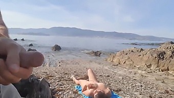 A Man Exposes Himself To A Nude Middle-Aged Woman On The Beach, Who Then Proceeds To Perform Oral Sex On Him